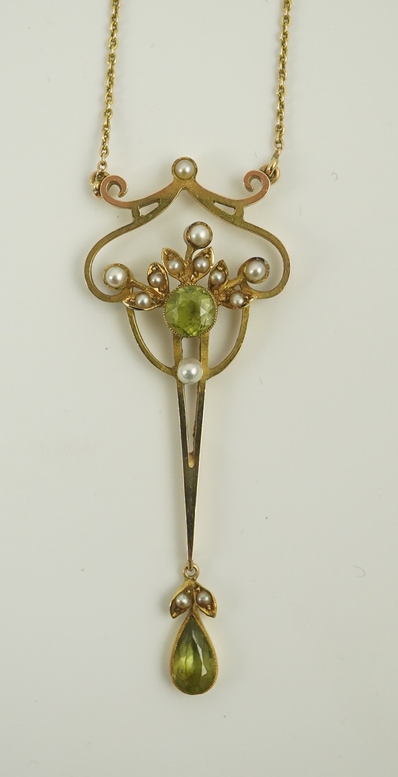 An early 20th century style gold, peridot and seed pearl set drop pendant, on an 18k gold chain